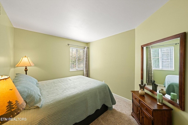 bedroom featuring light carpet