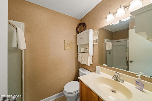 bathroom with vanity, toilet, and walk in shower