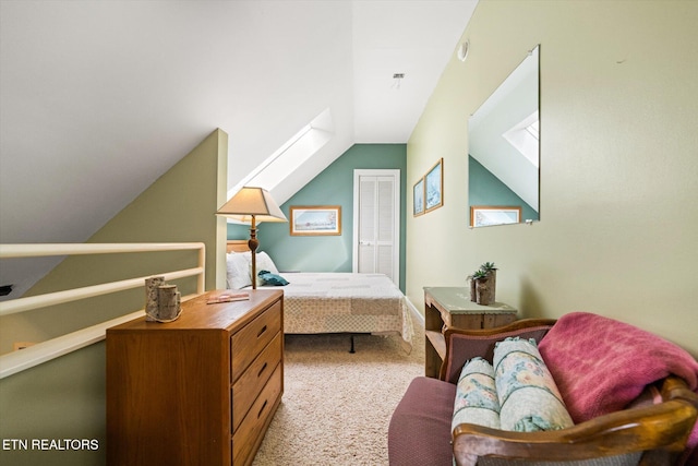 bedroom featuring light colored carpet, a closet, and lofted ceiling