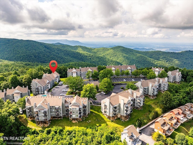 birds eye view of property with a mountain view