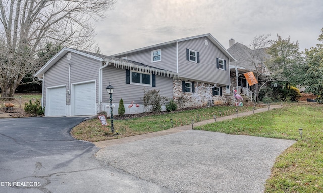 view of front of home with a garage and a front yard