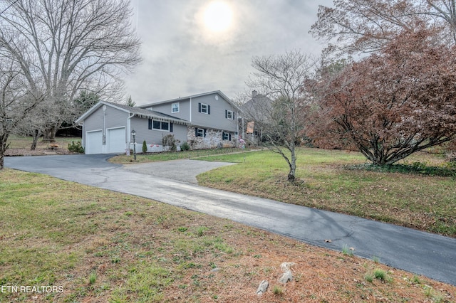 view of front of house with a garage and a front lawn