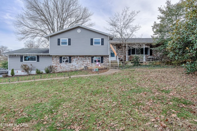 rear view of property featuring a yard