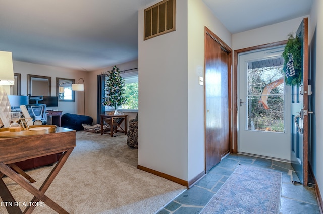 foyer featuring carpet flooring