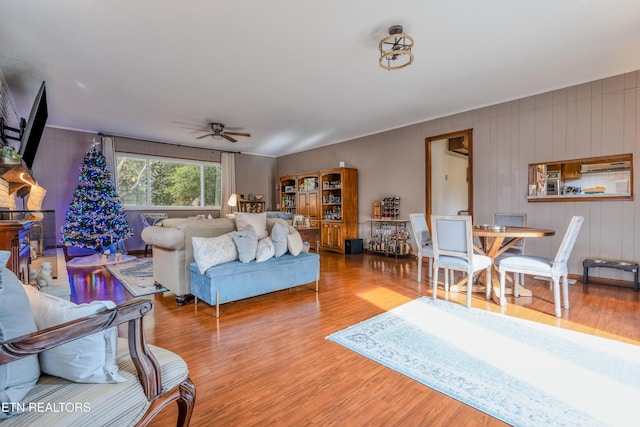 living room with wood-type flooring and ceiling fan