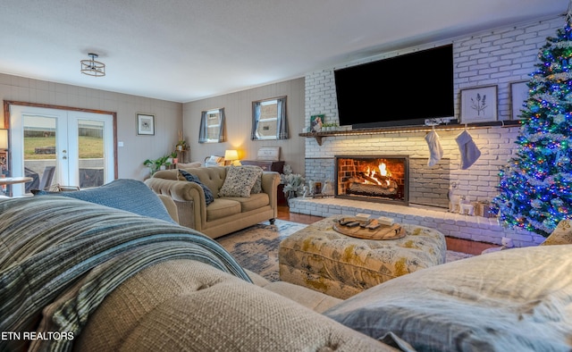 living room with french doors and a brick fireplace