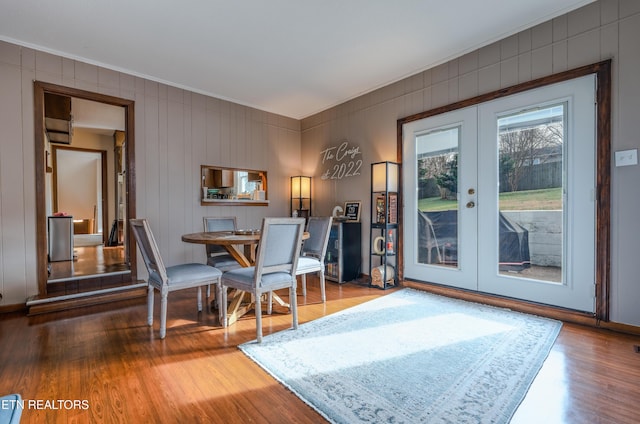 dining room with french doors, ornamental molding, and hardwood / wood-style floors