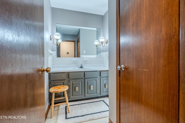 bathroom with vanity and tasteful backsplash