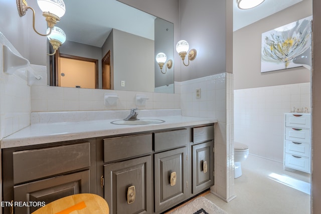 bathroom featuring vanity, toilet, and tile walls