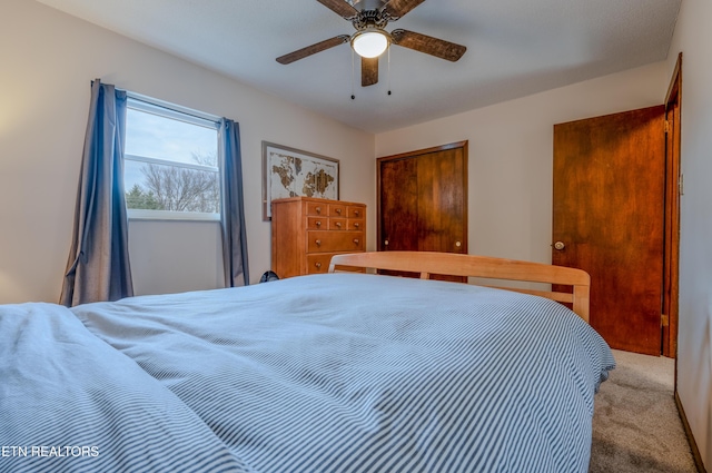 carpeted bedroom featuring ceiling fan