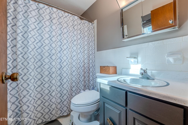 bathroom with vanity, tile walls, and toilet