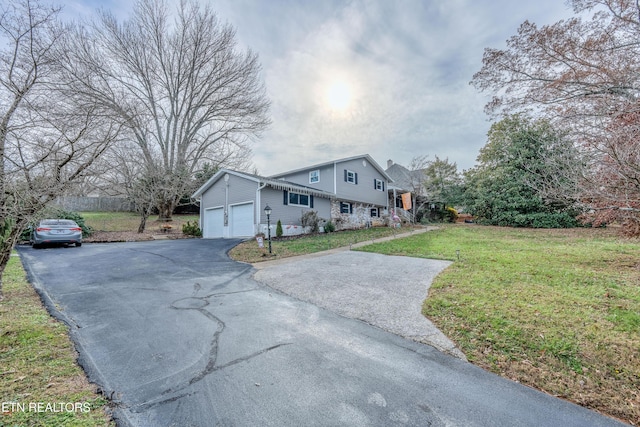 view of front of home with a front lawn and a garage