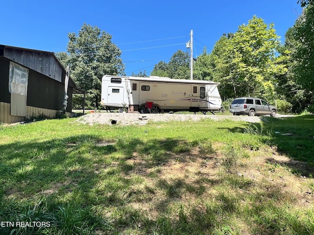 rear view of house featuring a yard