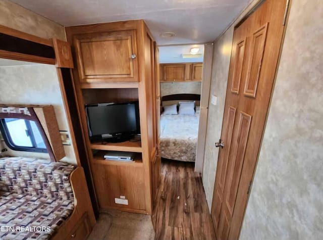 unfurnished bedroom with dark wood-type flooring