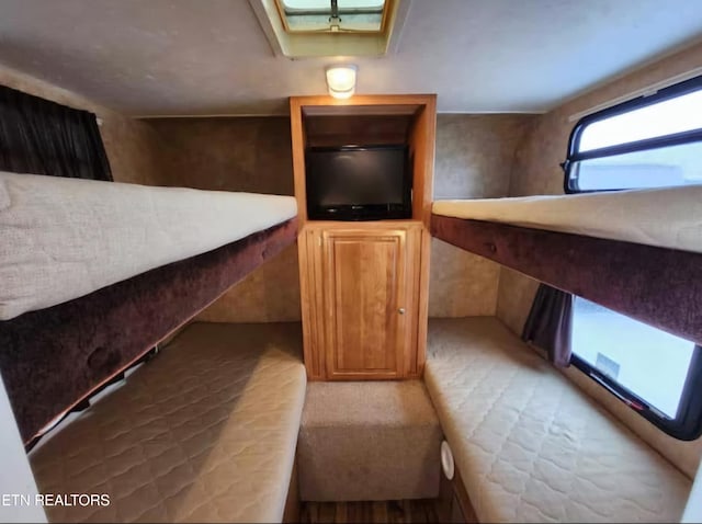 unfurnished bedroom featuring a skylight