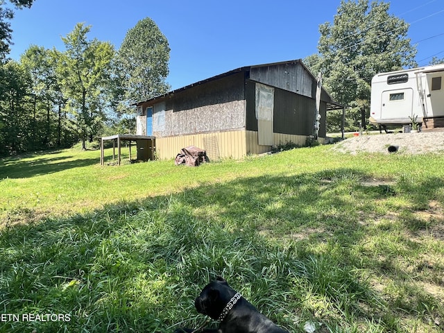 view of side of home with a lawn