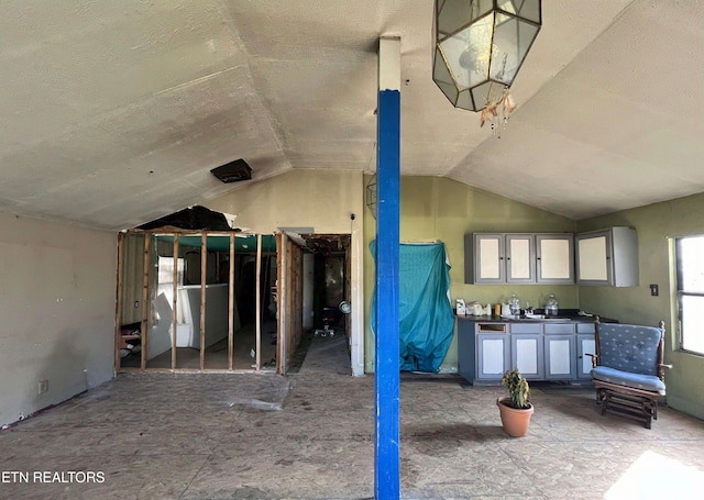 misc room with lofted ceiling and a sink