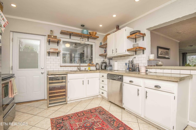 kitchen featuring white cabinets, beverage cooler, light tile patterned floors, and appliances with stainless steel finishes