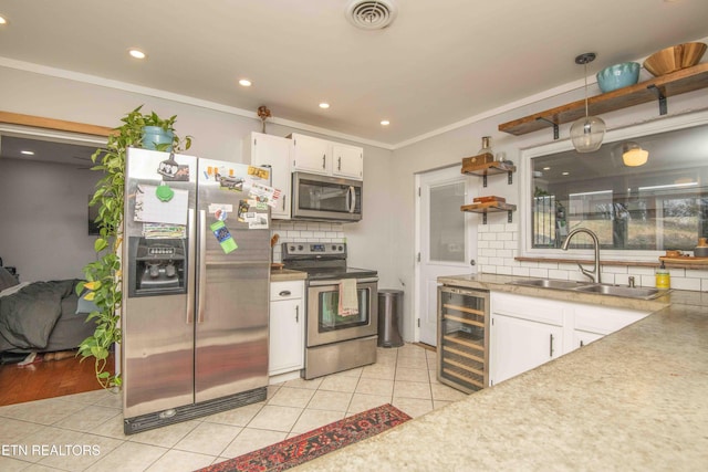 kitchen featuring white cabinets, sink, wine cooler, light tile patterned floors, and stainless steel appliances