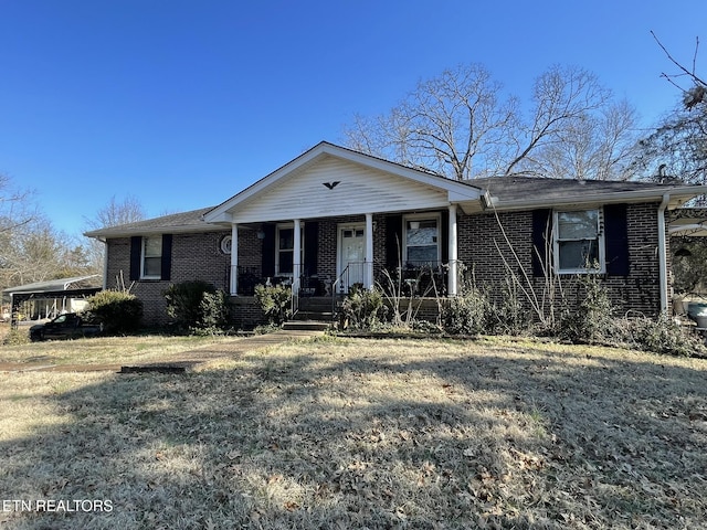 single story home featuring covered porch and a front lawn