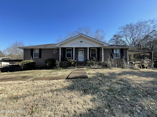 single story home with a porch and a front lawn