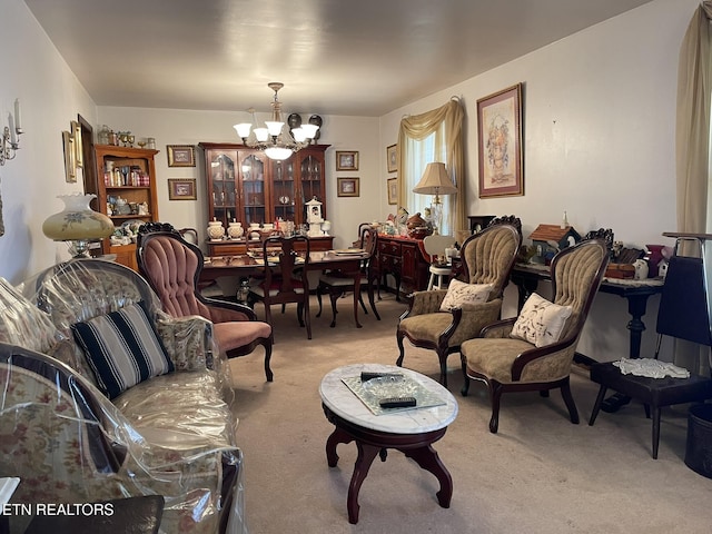 living room with light colored carpet and an inviting chandelier