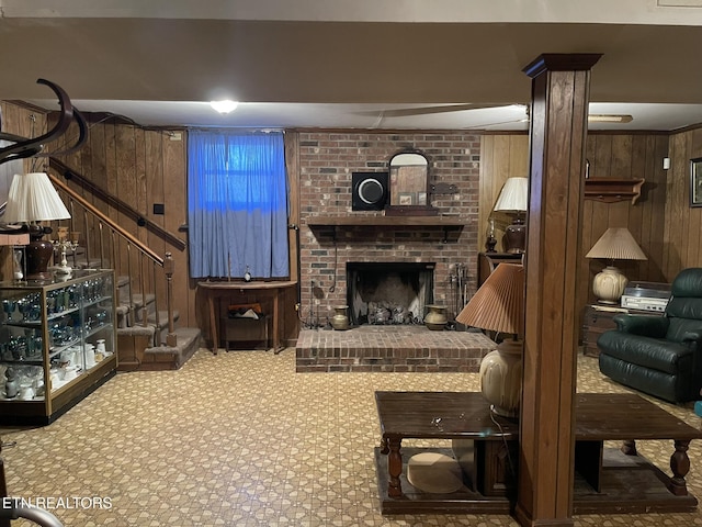 living room featuring carpet flooring, a brick fireplace, and wood walls