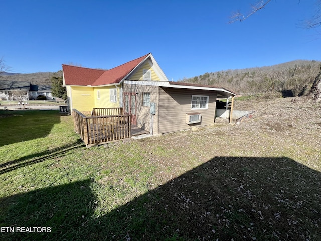 rear view of house featuring a yard