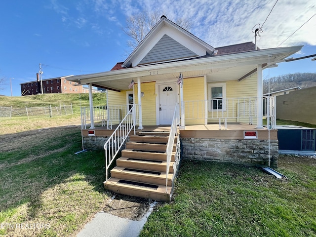 view of front of home with a porch and a front yard