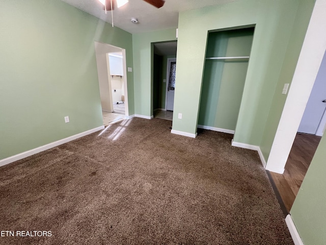 unfurnished bedroom with ceiling fan, a closet, dark carpet, and a textured ceiling