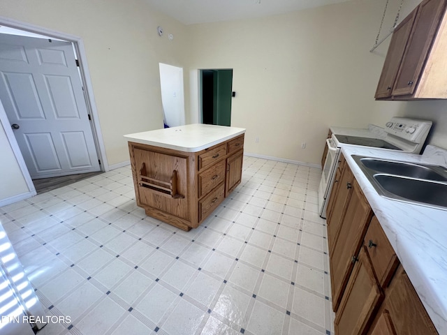 kitchen with range with electric cooktop and a kitchen island