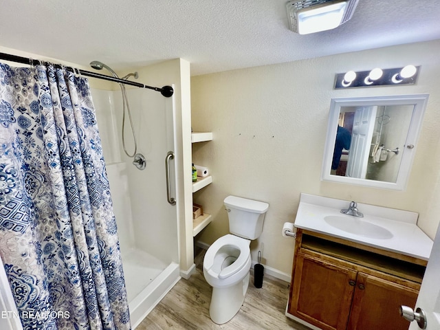 bathroom featuring hardwood / wood-style floors, vanity, a shower with shower curtain, toilet, and a textured ceiling