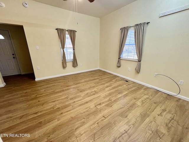 empty room with light hardwood / wood-style floors and ceiling fan