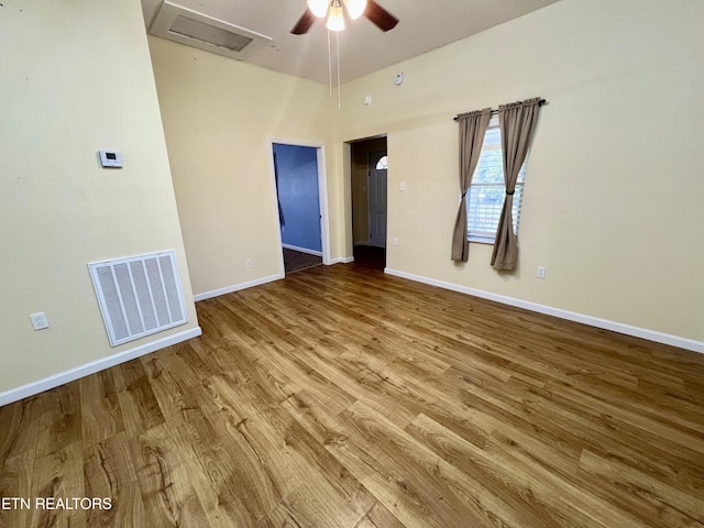 unfurnished room with ceiling fan and hardwood / wood-style flooring