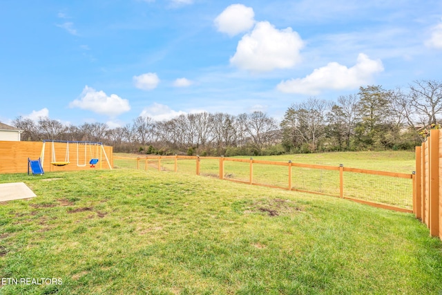 view of yard with a playground and a rural view