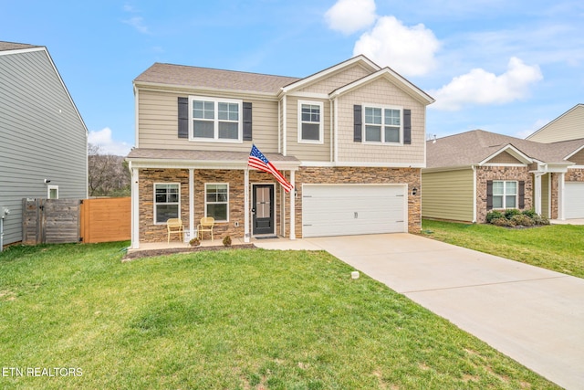 view of front of house featuring a porch, a front yard, and a garage