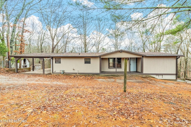 single story home featuring a carport