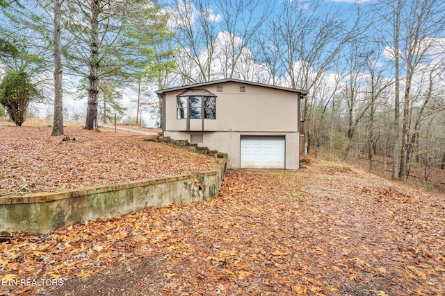 view of side of property with a garage