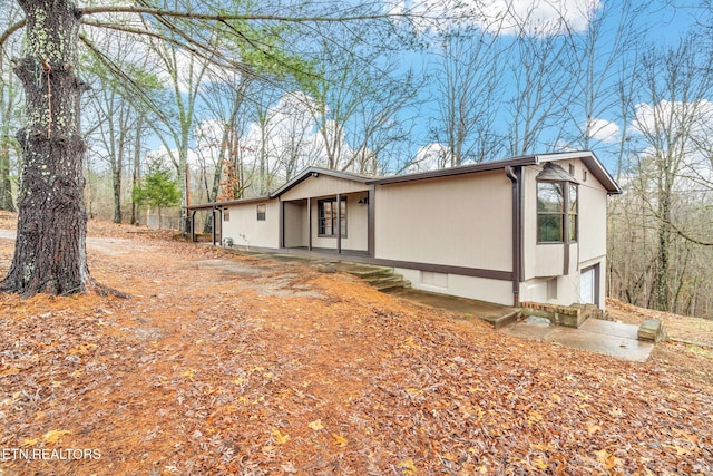 view of side of property featuring a porch and a garage