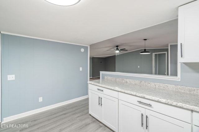 kitchen with hanging light fixtures, light hardwood / wood-style flooring, ceiling fan, ornamental molding, and white cabinetry