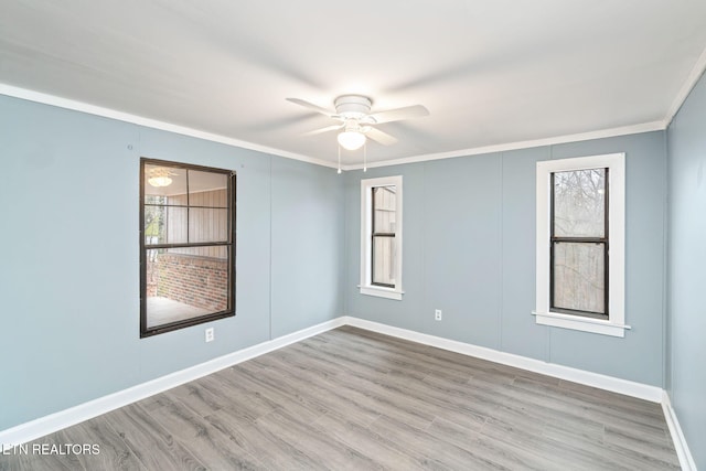 spare room with ceiling fan, ornamental molding, and light hardwood / wood-style flooring