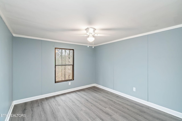 spare room featuring light hardwood / wood-style floors, ceiling fan, and crown molding