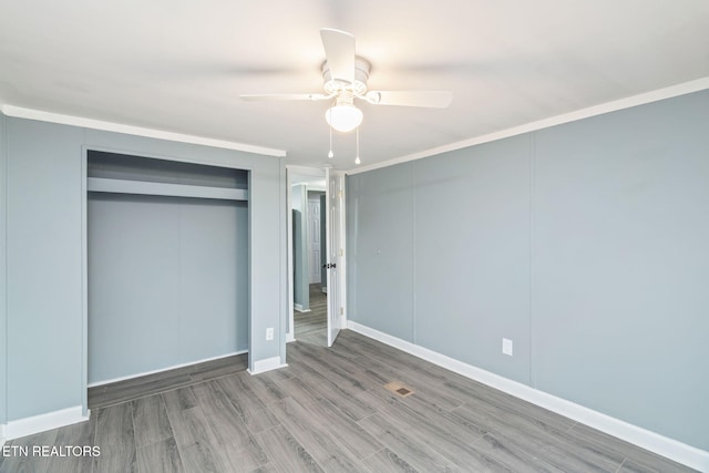 unfurnished bedroom featuring hardwood / wood-style floors, ceiling fan, and ornamental molding