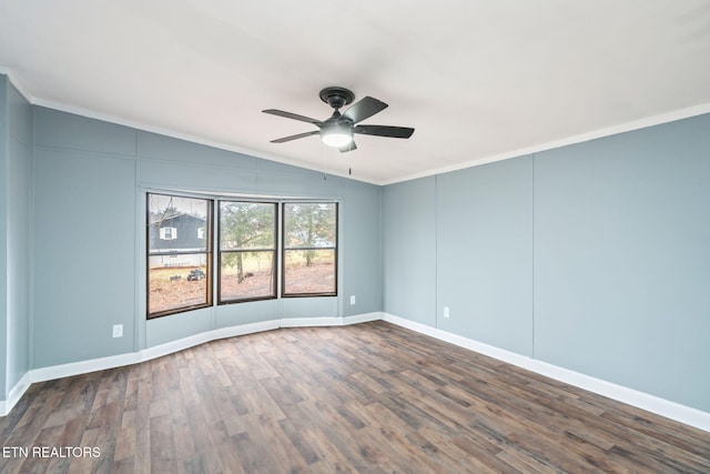 spare room with crown molding, dark wood-type flooring, and lofted ceiling