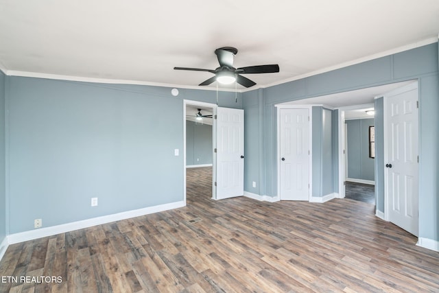 unfurnished bedroom with ceiling fan, crown molding, and hardwood / wood-style flooring