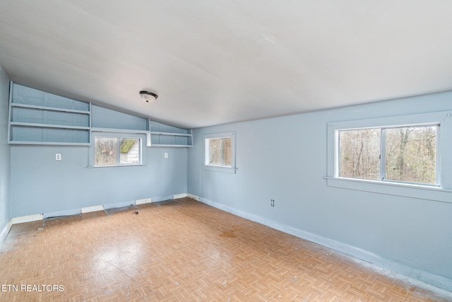 unfurnished room featuring lofted ceiling and light parquet floors