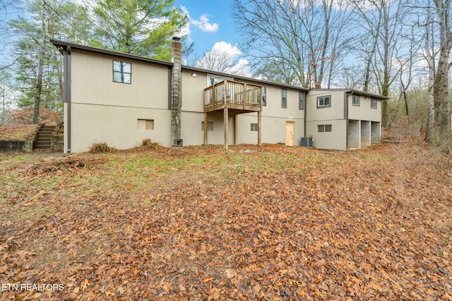 rear view of property featuring central AC unit and a deck