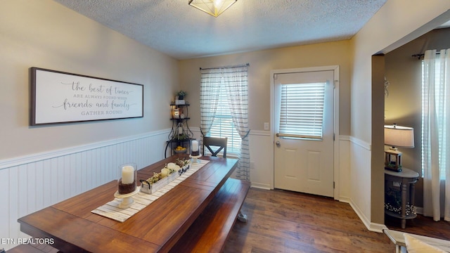 office area with dark wood-type flooring and a textured ceiling