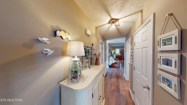 hall featuring dark hardwood / wood-style floors and a textured ceiling