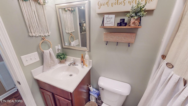 bathroom featuring vanity and toilet